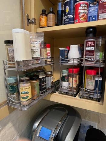 Kitchen cabinet with organized spices on pulled out rack