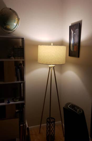 Lightbulb installed in a lamp, lighting it up 