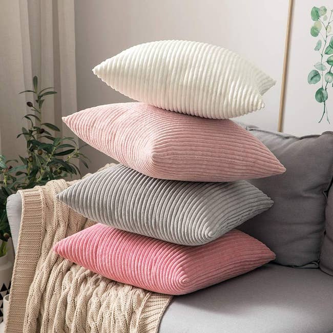 the corduroy throw pillow covers in shades of pink, gray, and white
