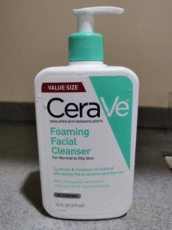 a reviewer photo of the pump bottle of the cleanser 