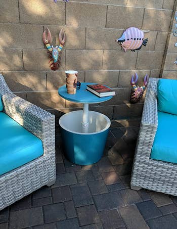 reviewer image of table cooler between two patio chairs