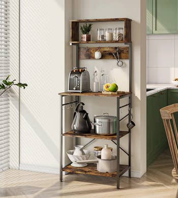 the baker's rack in rustic brown holding kitchen appliances and other items