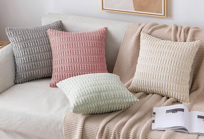 grey, pink, green, and cream colored throw pillow covers