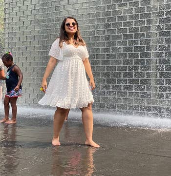 reviewer photo wearing white dress stepping in fountain