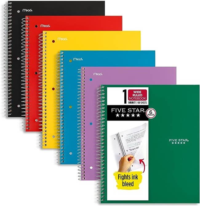 Six of the spiral notebooks in black, red, yellow, blue, purple, and green