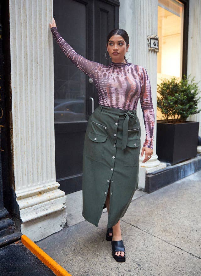 model wearing the button-front cargo skirt in green
