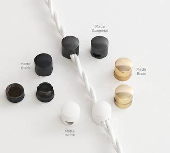 The cord organizers in white, black, and brass 
