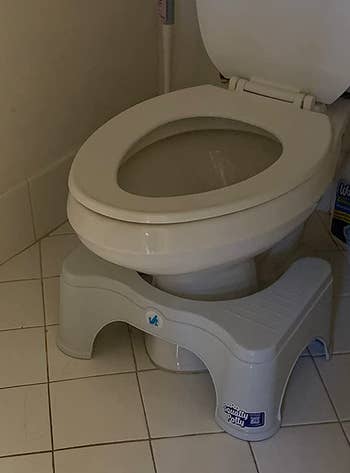 a reviewer photo of the stool in front of a toilet 