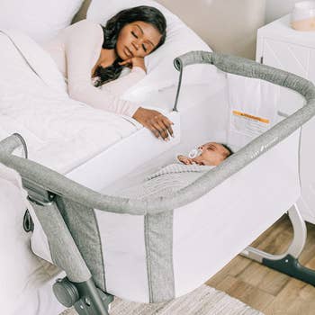 parent sleeping with open bassinet right beside the bed