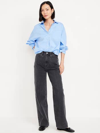 Person successful  a casual look   with a escaped   button-up garment  and high-waisted jeans, perfect  for smart-casual styling