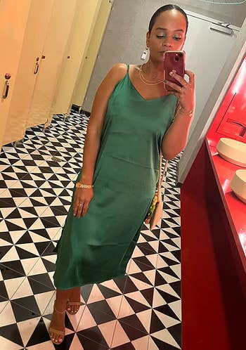 reviewer wearing the green slip dress with tan heels