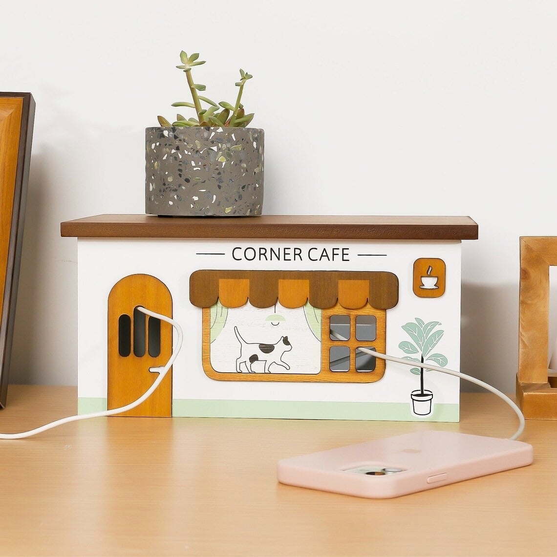 a wooden box designed to look like a cafe but it's actually a cord organizer