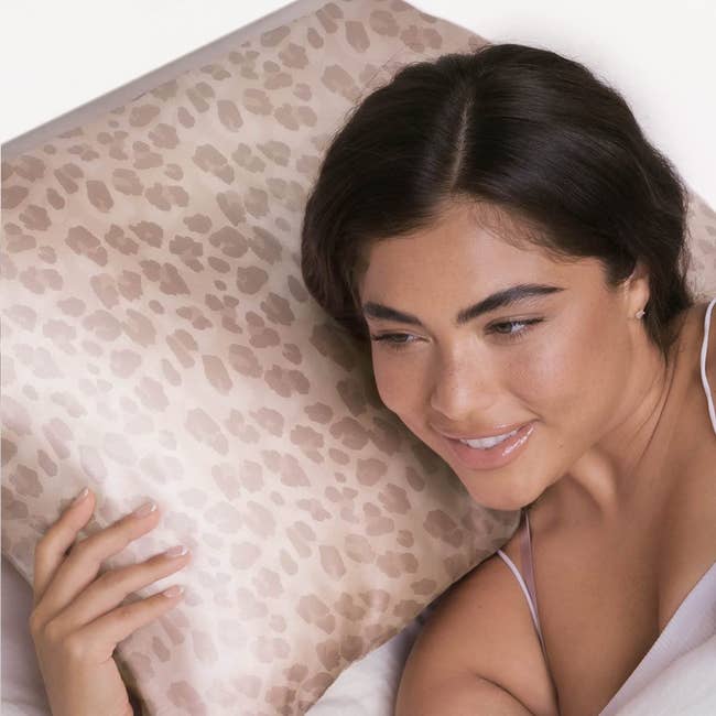 Model laying on the leopard print pillowcase 