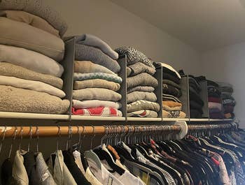 top of reviewer's closet with stacks of sweaters in between the dividers