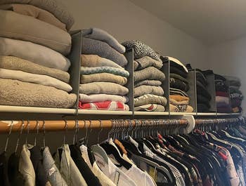 top of reviewer's closet with stacks of sweaters in between the dividers