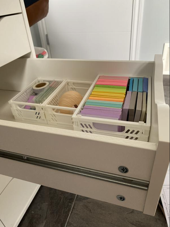 the white crates in a reviewer's desk drawer