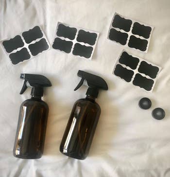 reviewer photo of the set including two amber spray bottles, labels, and screw caps