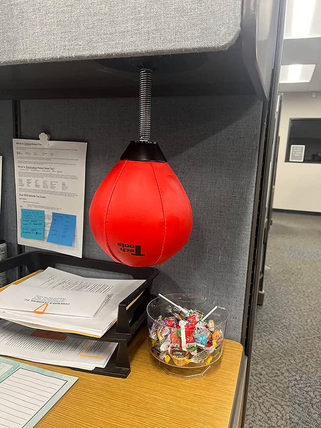 a reviewer's desk with the punching bag hanging from it