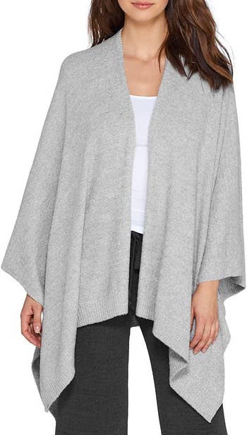 front view of a model wearing the shawl in grey