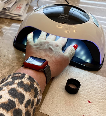 reviewer's hand under the uv lamp