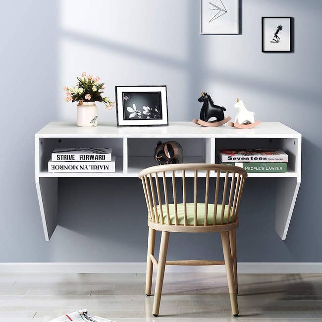 white wall-mounted desk with storage cubbies