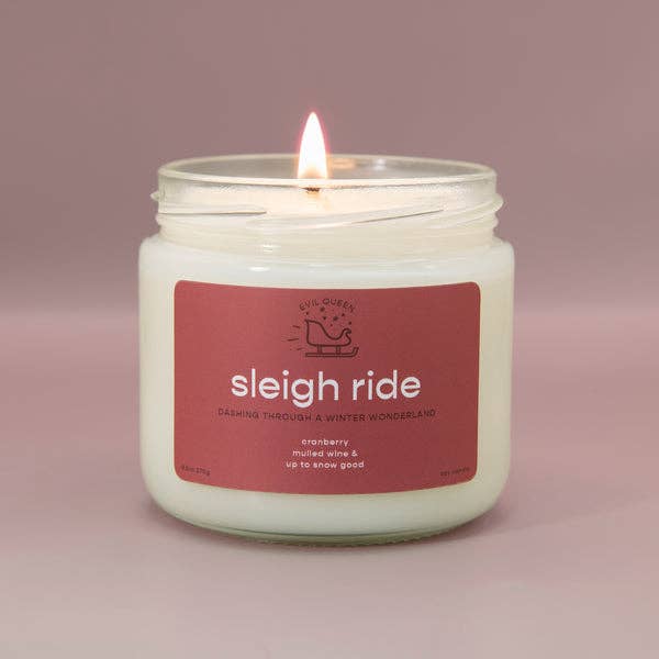 a candle  with a cranberry colored label that says 
