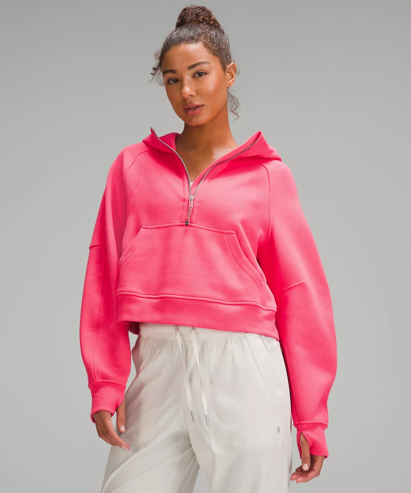 Model wearing a cropped pink hoodie