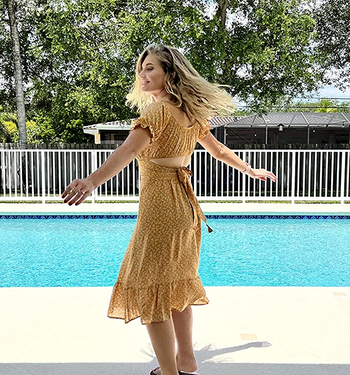 back/side view of reviewer wearing the yellow skirt set to show the tie in the back