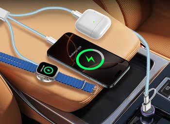 Smartphone, wireless earbuds, and smartwatch charging successful  a car   utilizing antithetic  cables connected to a car   USB charger