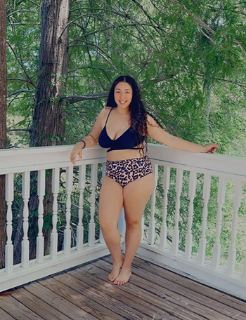 reviewer wearing the suit with a black top and cheetah print bottom