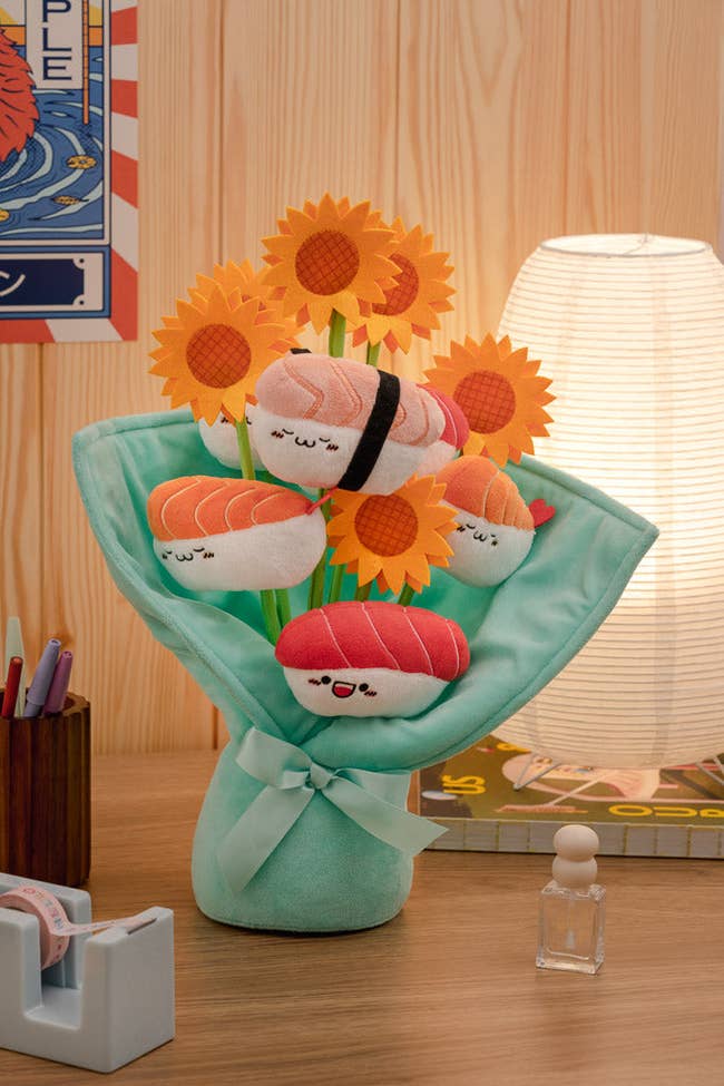 plush bouquet of sunflowers and smiley face sushi on stems with mint green plush wrapping