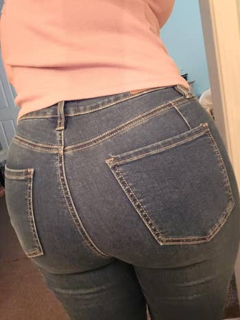Person wearing fitted denim jeans and a casual top