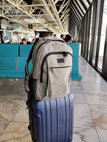 reviewer's backpack sitting on a suitcase