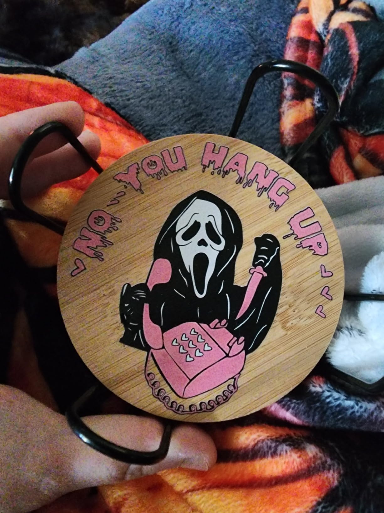 Round bamboo coaster featuring Ghostface with a pinkish  phone, substance   reads 