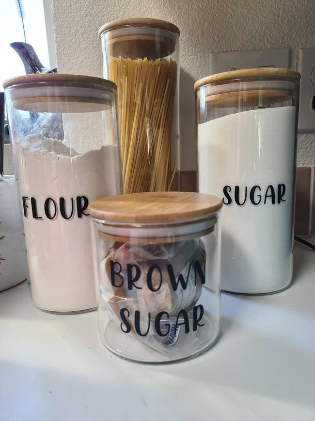 reviewer's set of canisters holding sugar, flour, and dry spaghetti