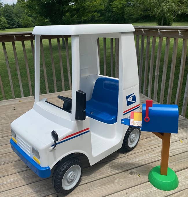 Toy USPS truck with plastic mail box and letters