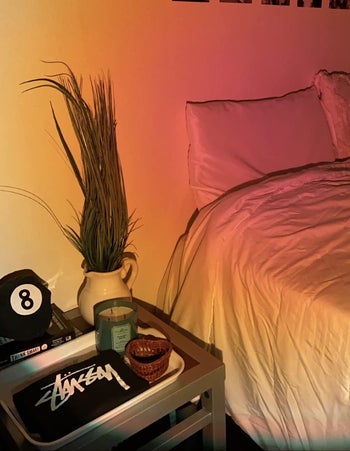 reviewer photo of sunset light on bedspread