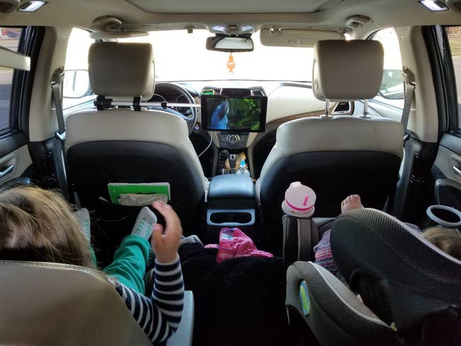 reviewer photo of a mounted tablet and two children watching a movie on the tablet