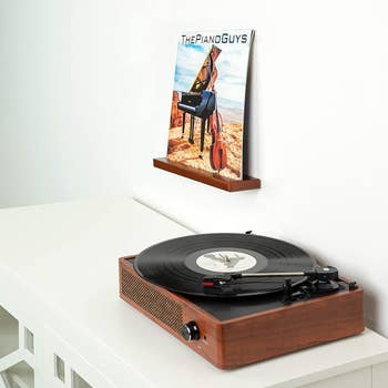 a record on a shelf next to a record player