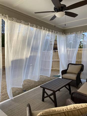 sheer curtains hung outside with light filtering through