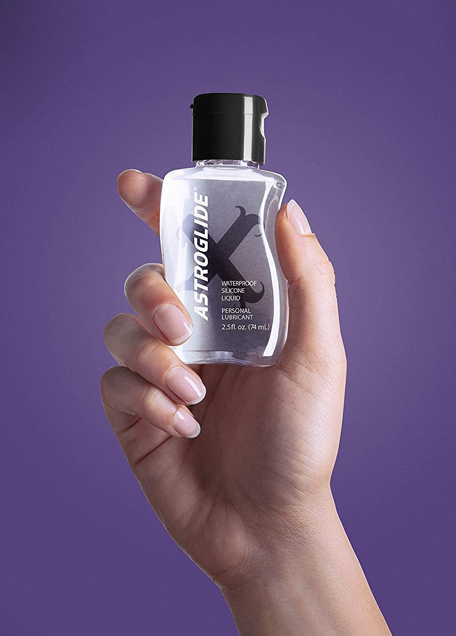 Model holding bottle of Astroglide X lubricant
