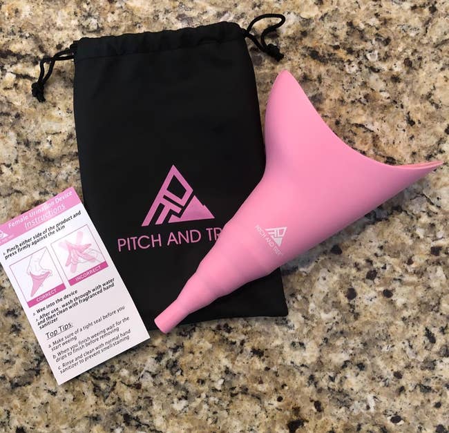 reviewer image of the pink funnel-shaped urinal device