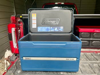 Open Coleman Snap 'N Go cooler connected  a motortruck  furniture  with compartments, showing retention  space
