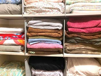 another rviewer's linen closet with shelf dividers to divide stacks of towels