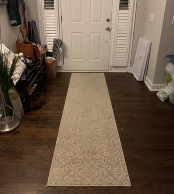 A runner rug securely placed in a front hallway 