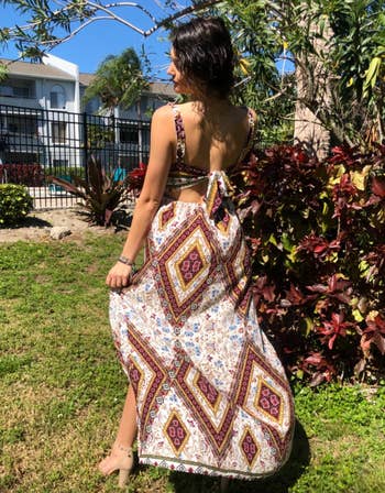 reviewer showing the back of the maxi dress