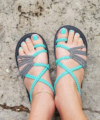 reviewer wearing the teal sandals