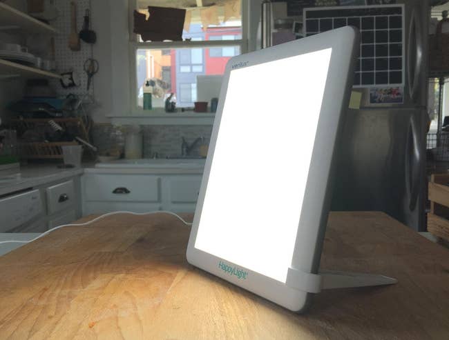 reviewer's light therapy lamp on kitchen counter