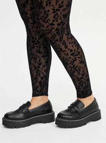 Black loafers with heavy soles worn with floral-patterned leggings