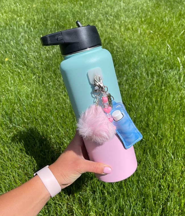 image of reviewer holding up the bubble gum colored 30 ounce iron flask water bottle